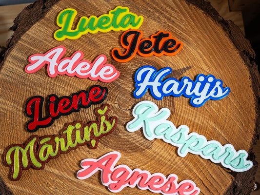 Colorful name patches on a wooden surface