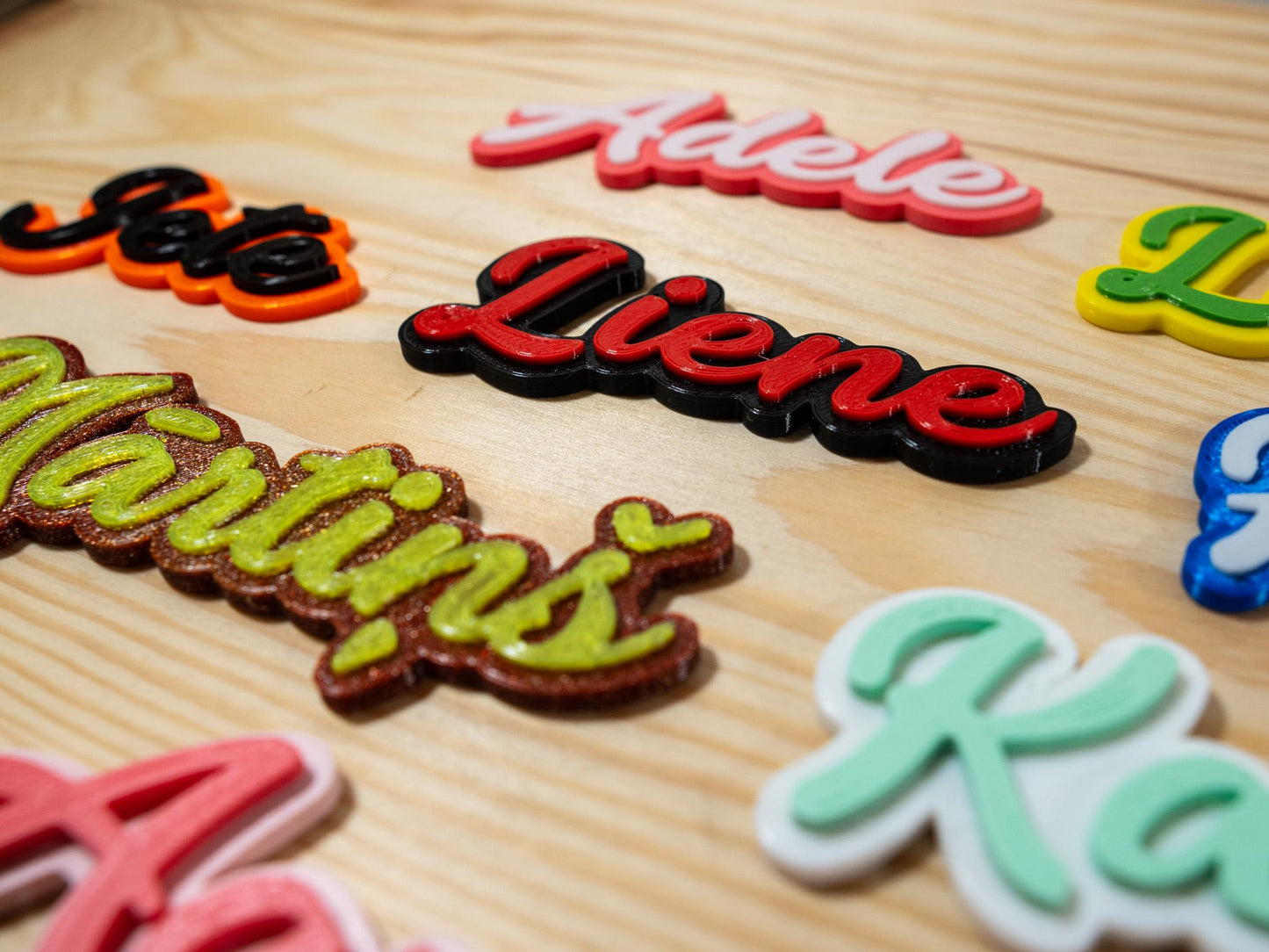 Colorful name magnets on a wooden surface