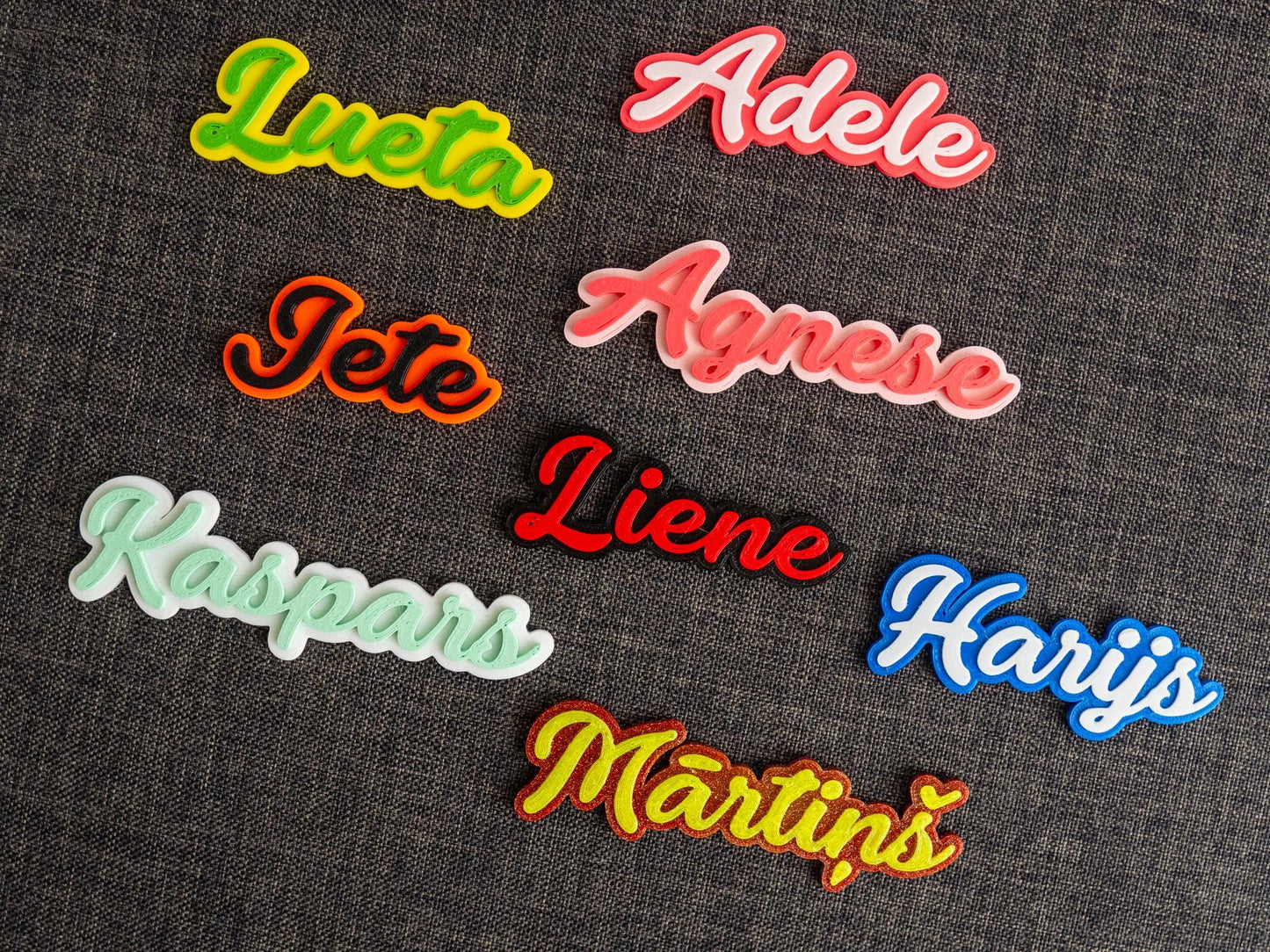 Colorful name patches on a dark fabric background