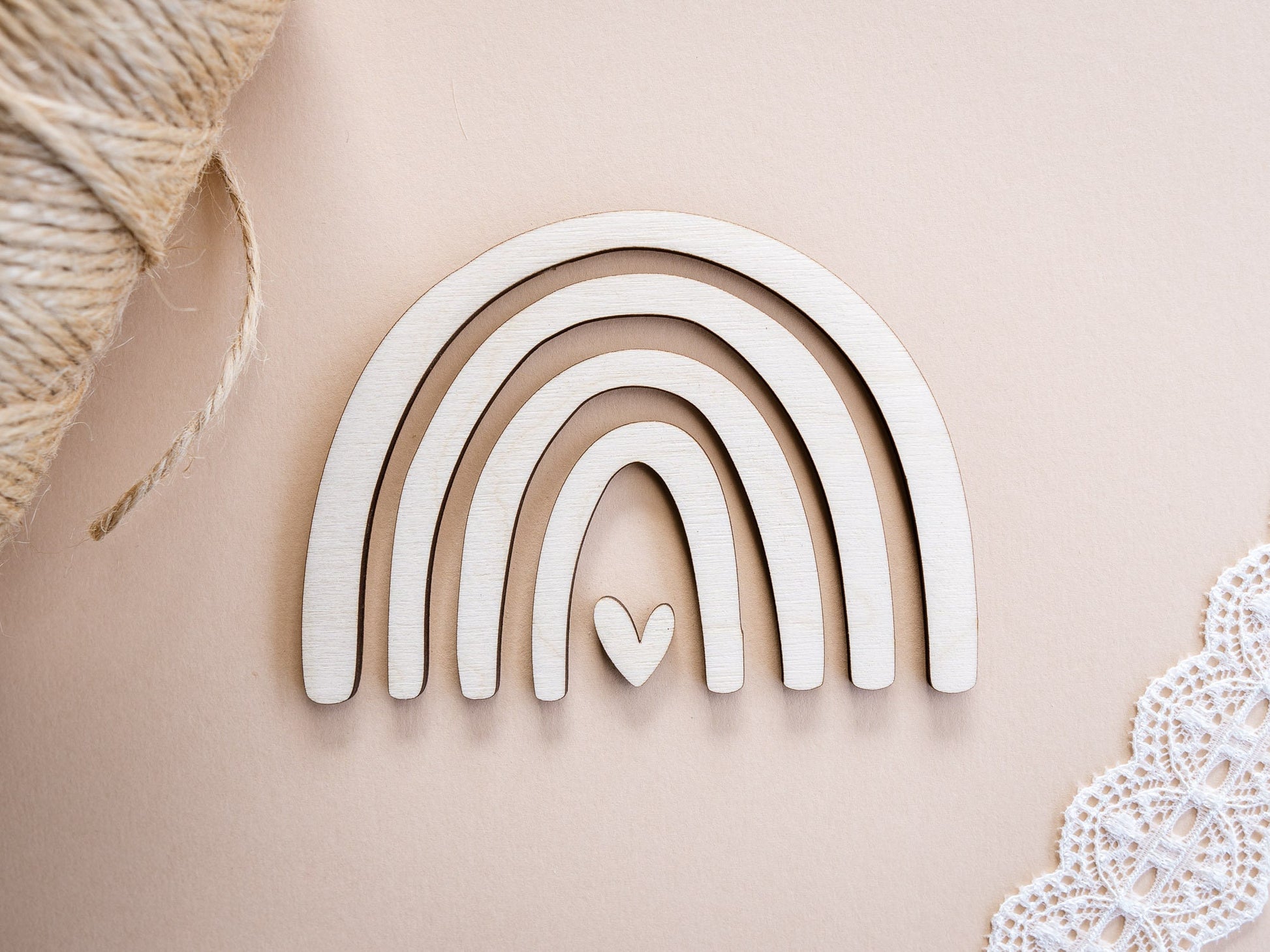 Decorative wooden rainbow with a heart on a beige background