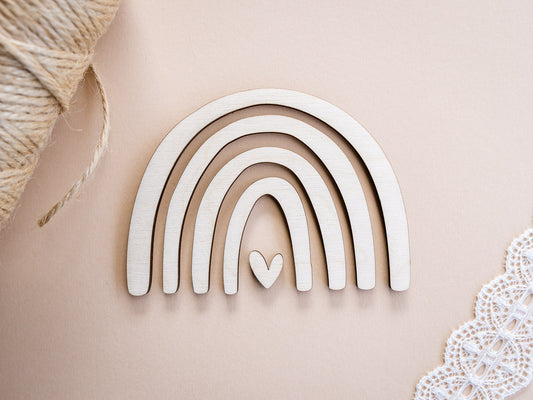 Decorative wooden rainbow with a heart on a beige background