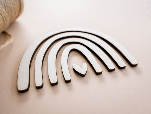 Wooden rainbow toy on a beige surface