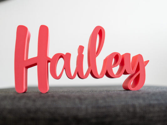 Red decorative name 'Hailey' on a gray surface with a white background