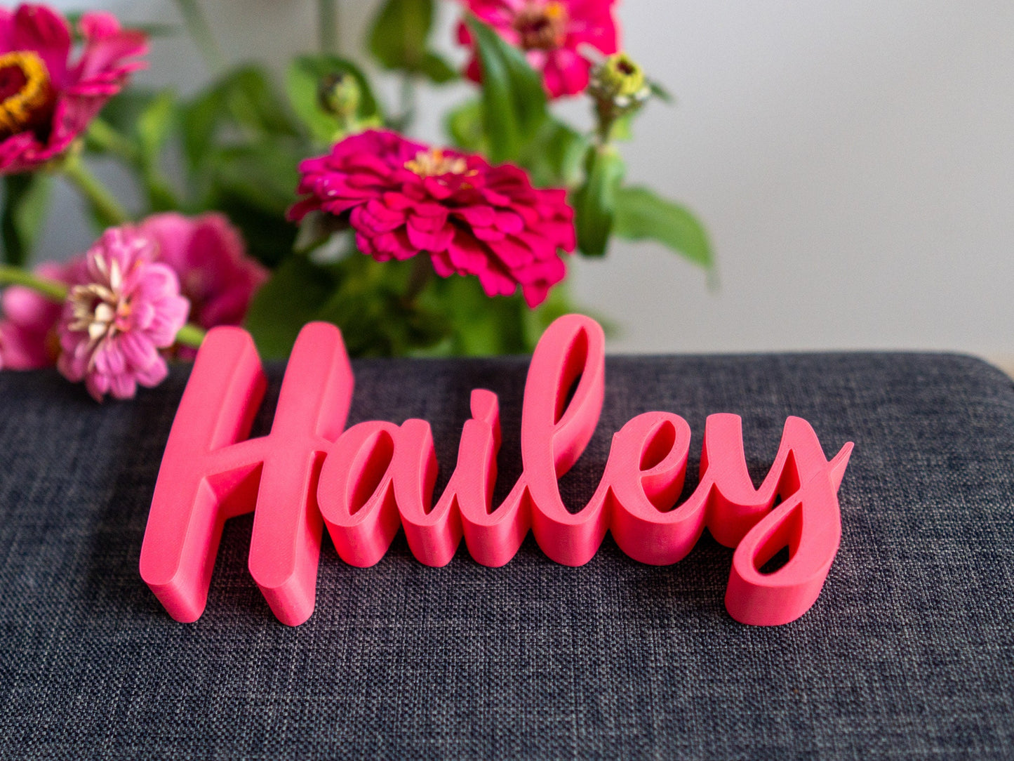 Red decorative name 'Hailey' on a gray surface with a white background