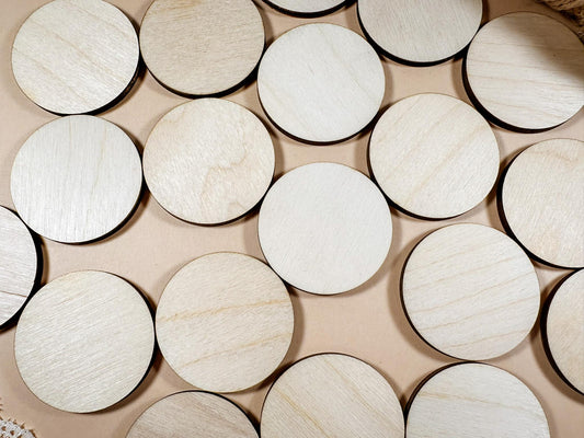 Round wooden coasters on a beige surface with lace and twine.