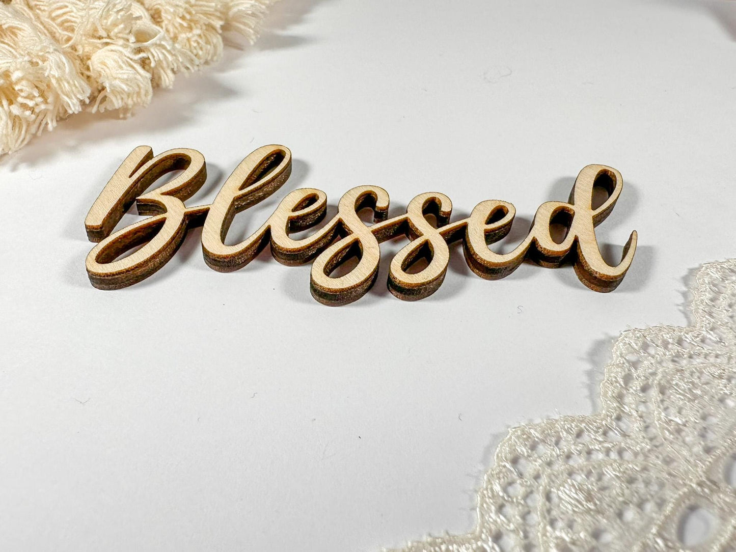 Wooden sign with the word "Blessed" written in cursive script.