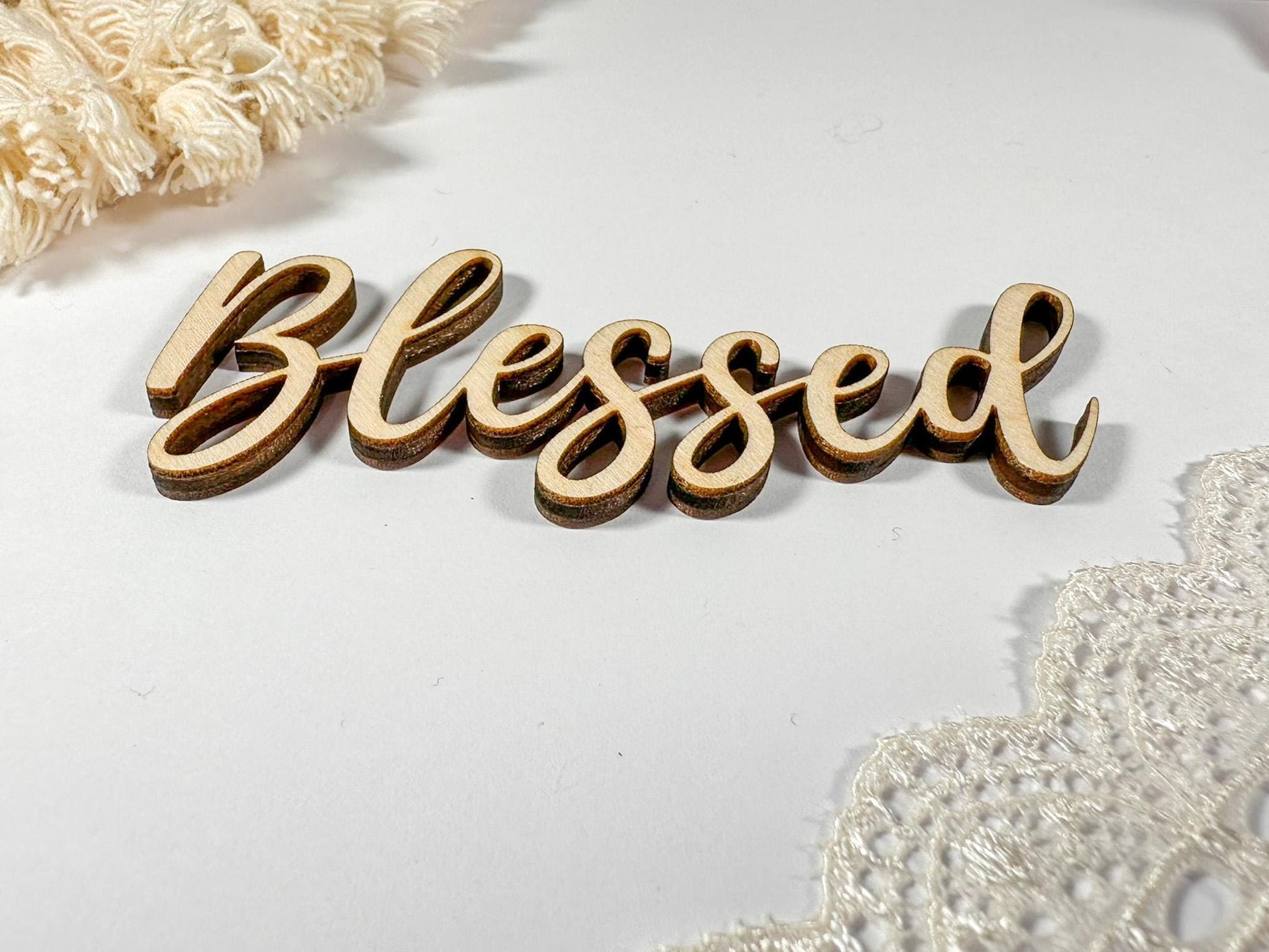 Wooden sign with the word "Blessed" written in cursive script.