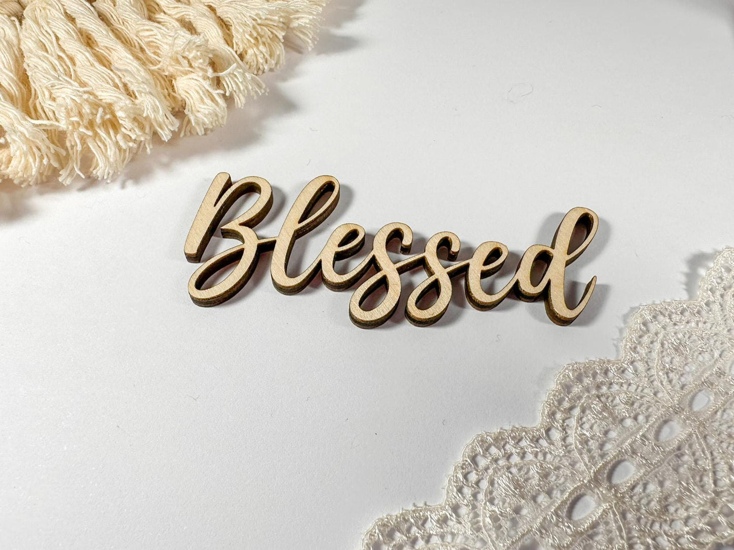 Wooden sign with the word "Blessed" written in cursive script.