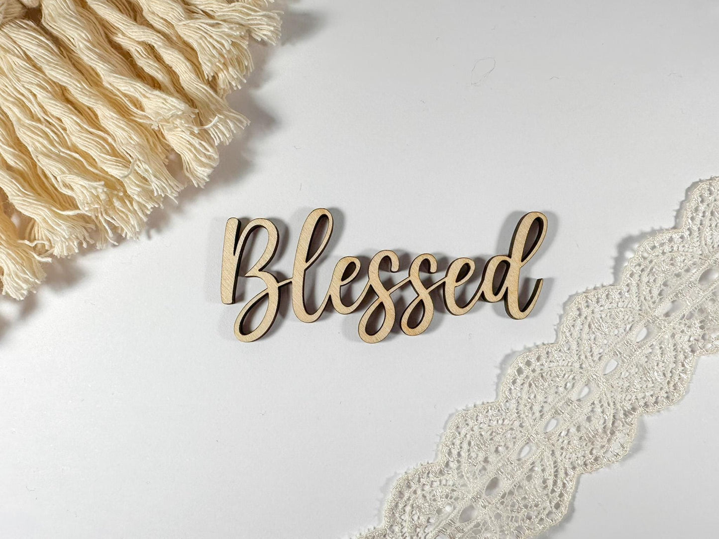 Wooden sign with the word "Blessed" written in cursive script.